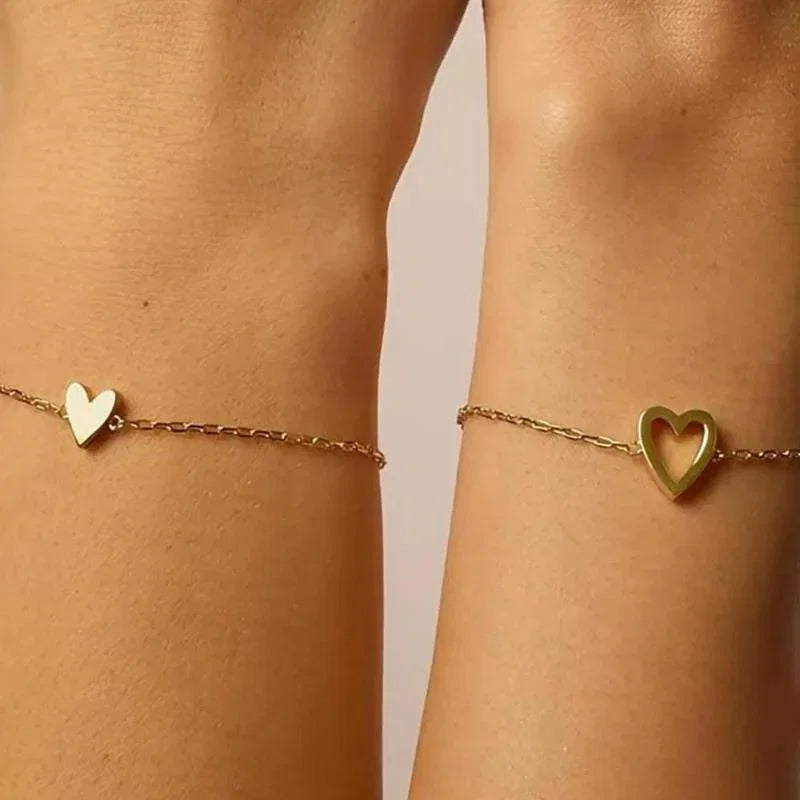 Matching Hearts Bracelet — solid and hollow heart bracelets that fit together, a mother and daughter set
